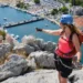 A woman enjoys the view from the top of Via ferrata Omis